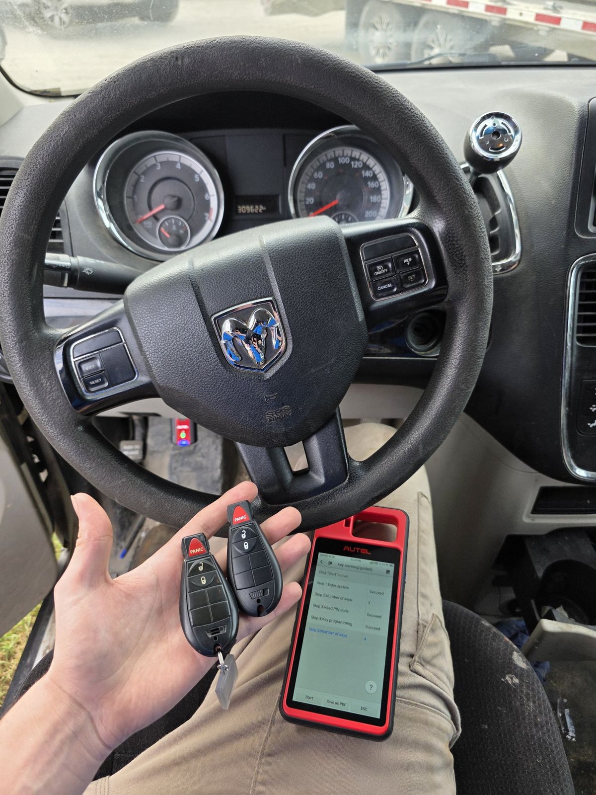 Key programming in progress at a Dodge steering wheel, the programmer showing key learning succeeded