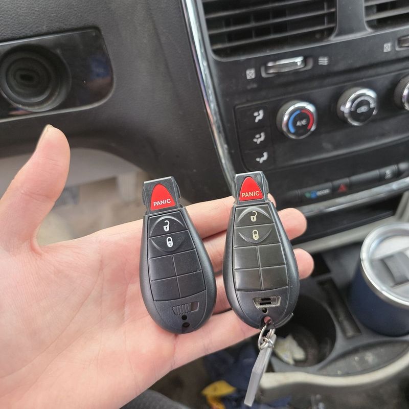 Two Dodge FOBIK keys held inside a Grand Caravan