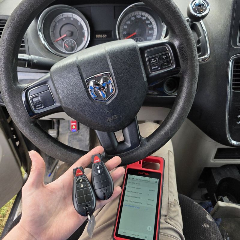 Key programming in progress at a Dodge steering wheel, the programmer showing key learning succeeded